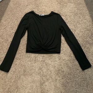 This is a black, cropped active wear long sleeve shirt.